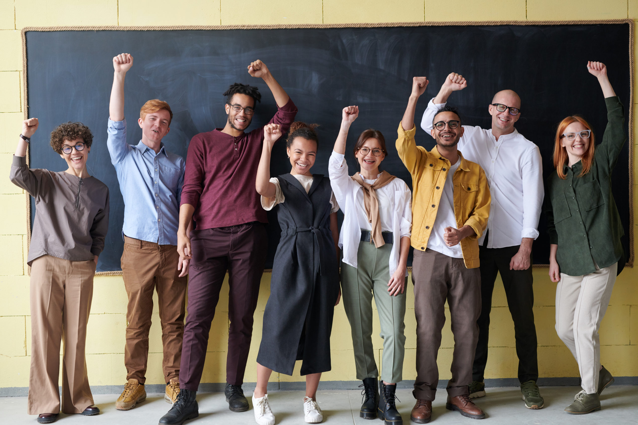 group-of-people-standing-infront-of-blackboard-3184432